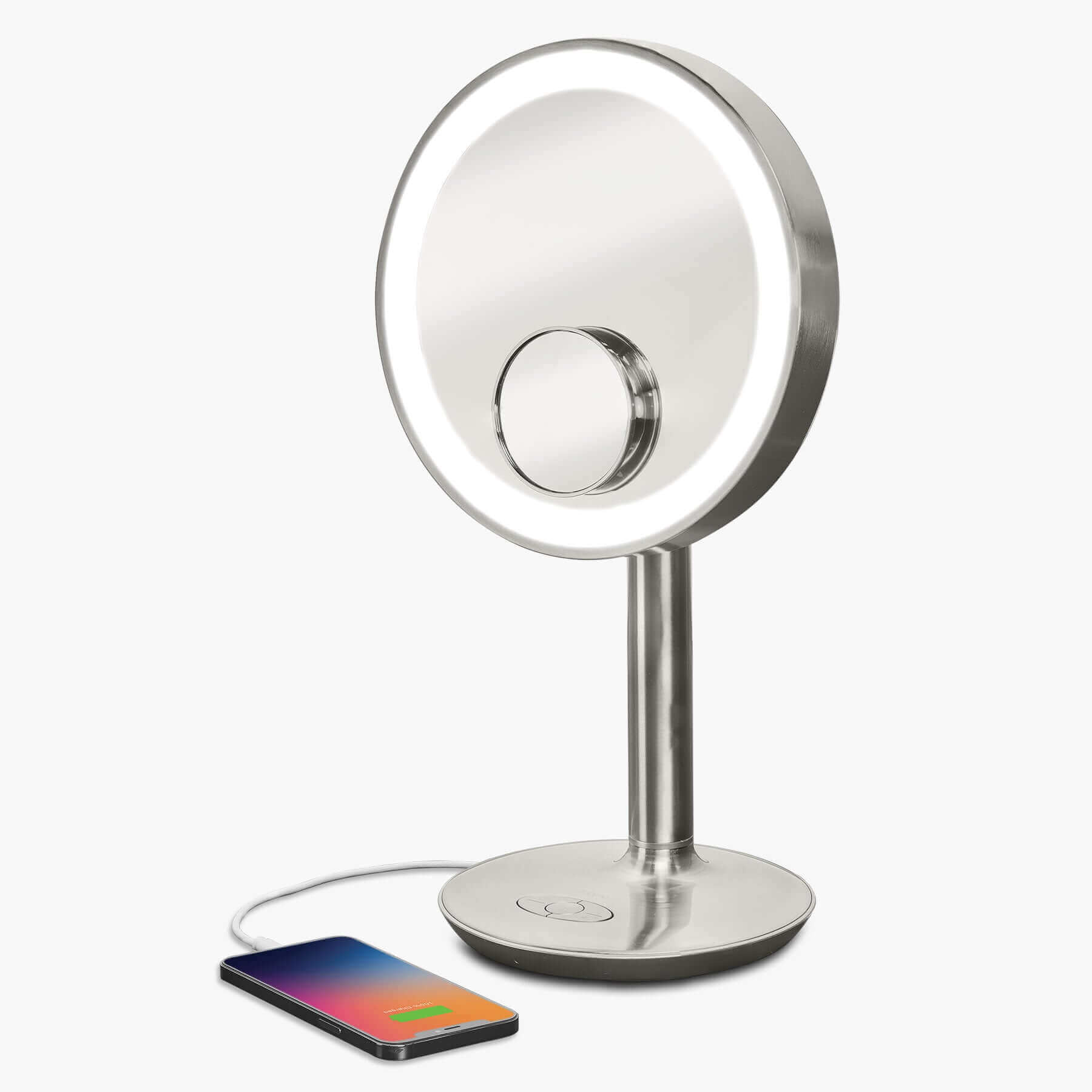 Vanity mirror with lights, wireless speaker, USB charging port, and removable magnifying mirror.